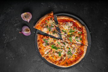 Pizza with a cut piece with arugula, parmesan, mozzarella, tomatoes and delicious stuffing