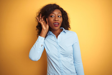 African american businesswoman wearing elegant shirt over isolated yellow background smiling with...