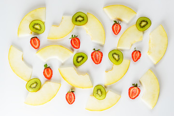 Melon slices, strawberry and kiwi fruit on a white background. Flat lay, closeup.