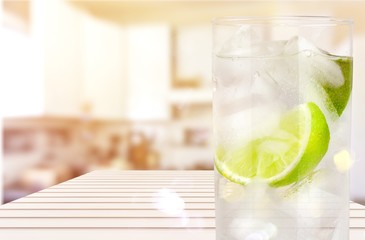 Glasses with fresh organic cucumber water on wooden table, on grey background