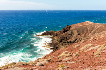 Fototapeta na wymiar Atlantic ocean waves at the base of Mount Bocinegro coastline near El Medano town, Tenerife, Spain
