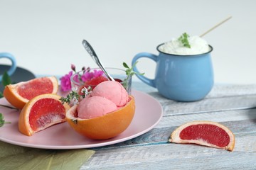  Natural ice cream, grapefruit, basil on a wooden table, tasty and healthy dessert, seasonal food