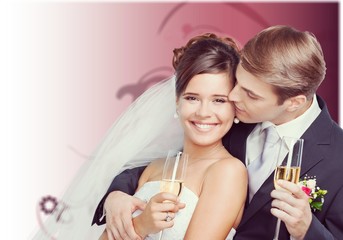 Young Wedding Couple Bride and Groom holding champagne glasses