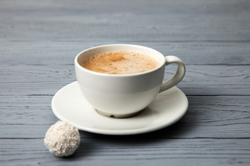 Cup of coffee with coconut candy