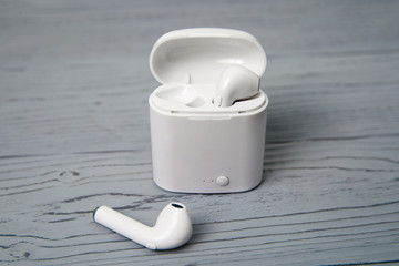 A set of wireless headphones on a wooden desk