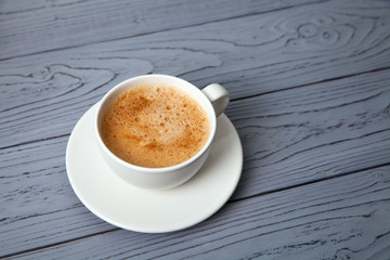 A white cup of coffee on table
