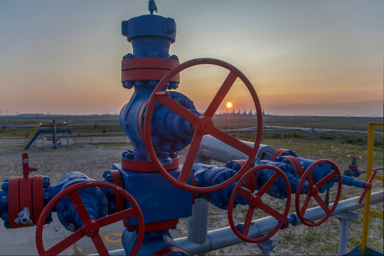 Group wellheads and valve armature , Gas valve, Gas well of high pressure, a wellhead with valve armature. Oil and gas industry concept. Industrial site background. Toned.
