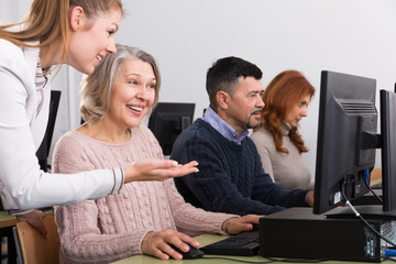 Happy mature woman studying with coach