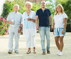 elderly friends walking outdoo