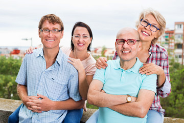 Portrait of smiling mature people in glasses outdoors together