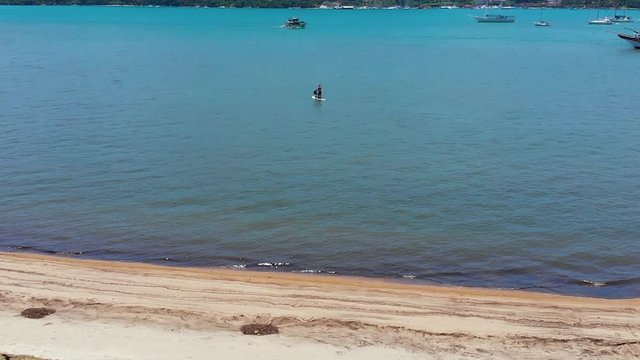 Stand up paddle surfing, Atlantic ocean (Paraty, Brazil) aerial view, drone footage