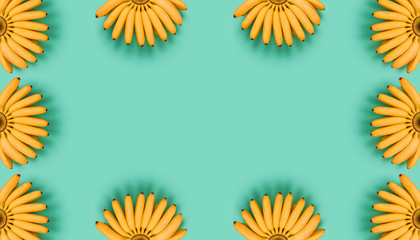 Trendy colorful fruit pattern of yellow bananas on blue background. Tropical abstract background. Minimal summer concept. Seamless pattern with bananas