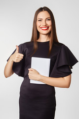 Attractive brunette in a business style in the studio on a white background