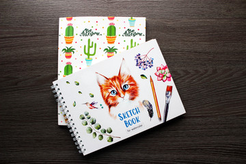 Sketch books on wooden background