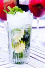 Mojito on wooden table in cafe. Blurred background cafe.