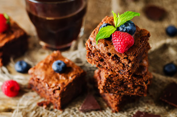 Chocolate brownie with berries and mint leaves