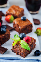Chocolate brownie with berries and mint leaves