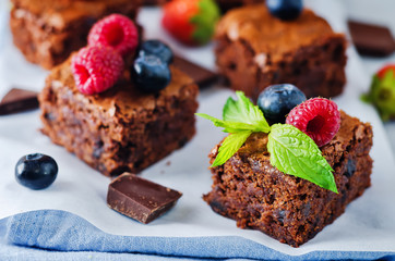 Chocolate brownie with berries and mint leaves