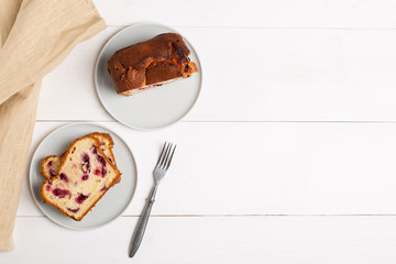 Homemade berry cake on white wooden background