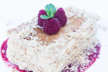 Restaurant with Napoleon Dessert or Mille-Feuilles owhite plate Background. Exquisite Serving Rectangular Piece of Millefeuille, With raspberry