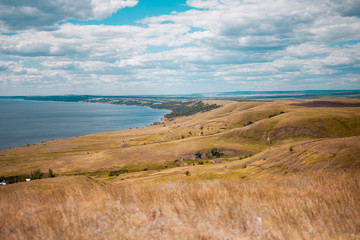 Beautiful landscape of hills, mountains and the river on a summer sunny day.
