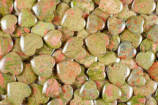 Bulk of unakite heart-shaped stones texture background