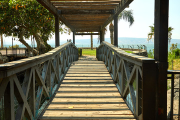 Wooden bridge with a roof on the Sea of Galilee, July 2019