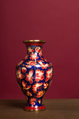 Antique Chinese Cloisonne enamel on a red background