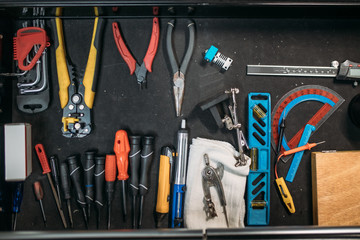 Wrench set of mechanic stuff for work or repair auto: pliers socket spanner and screwdriver tools on black background. Top view. Still life. Copy space. Flat lay