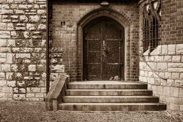 Entrance door to a church, Old door with metal ornaments, Sandstone wall, Brick wall with Entrance, black and white