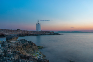 Old small lighthouse of the Aegina island, Saronic gulf, Greece, at sunset.
