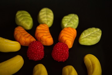 Fruit candy on black. Delicious fruit candy. Multicolored fruit candy.