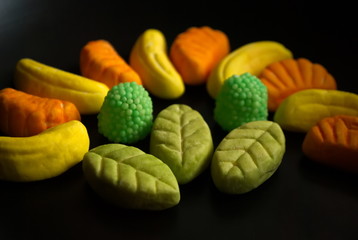 Fruit candy on black. Delicious fruit candy. Multicolored fruit candy.
