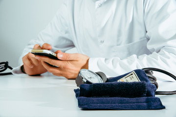 Fototapeta premium The doctor checks the information on the phone. Medical and pharmaceutical concept. The doctor provides information about the patient's health, treatment of diseases, health problems.