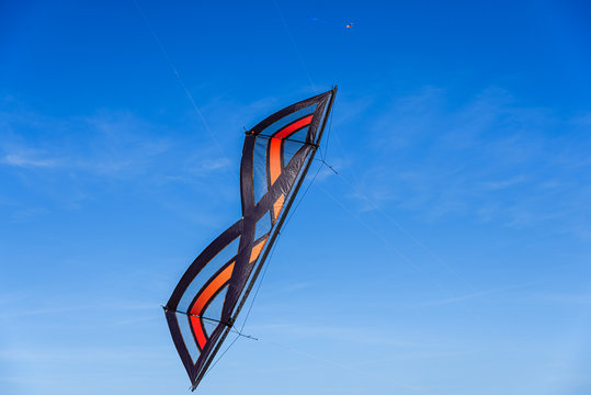 Acrobatic Stunt kite flying in the blue sky.