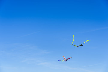 Colorful kite flying in the blue sky, negative space for copy.