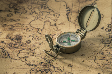a compass on an old map showing the direction