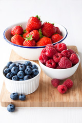 Fresh berries on a wooden chopping board