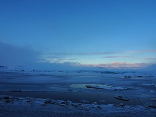 Fototapeta na wymiar Frozen sea and clouds with iceberg in Iceland in winter