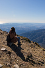 Naklejka premium Beautiful woman sitting after hiking during winter or autumn in Catalonia (Turo del Home - Spain)