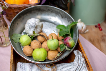 Walnuts and wild apples in metal plate