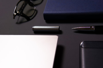 Notebook, laptop, glasses and pen on the table. Concept of business or study.