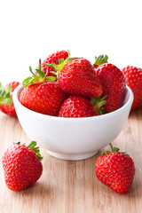 Fresh strawberries in white bowl