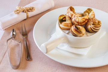 bourguignonne snail au gratin. dish with snails. fork for snails