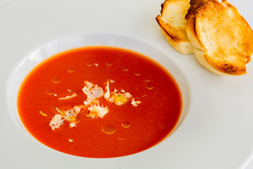 Bowl of tomato soup isolated on a white background