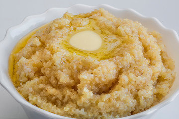 Wheat porridge on a plate white isolated background