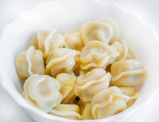 Appetizing dumplings, vareniki, ravioli, momo close-up. Traditional dish of Russia, Italy, Asia. Boiled dough with filling. Dumplings with meat, fish, vegetables. A hearty breakfast, lunch, dinner.