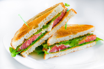 sandwich with red fish, lettuce and crispy bread rolls