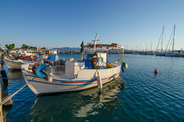 Fototapeta na wymiar Port of Aegina town with yachts and fishermen boats docked in Aegina island, Saronic gulf, Greece, at sunrise.