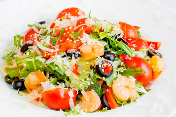Plate Caesar Salad with shrimp and seafood, home-made anchovies, butter, sauces, croutons, tomatoes, herbs and grated cheese